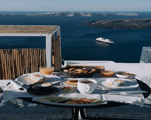 A healthy breakfast setup with a notebook on a bright balcony in Greece